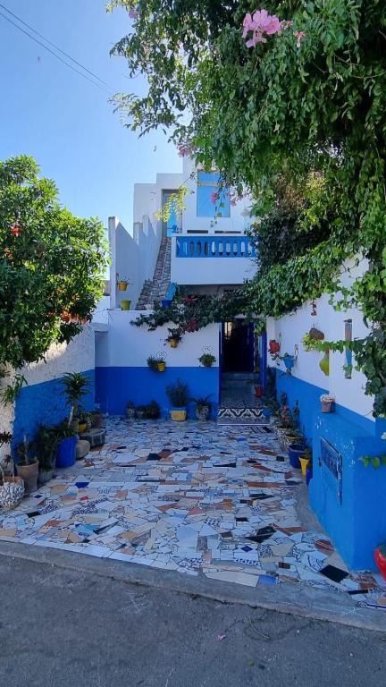 a blue and white building with a staircase at Maison Berj in Oualidia