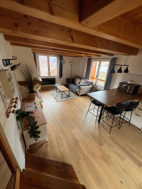 a living room with a table and a couch at Appart Duplex Chalet plein Sud in Feissons-sur-Salins