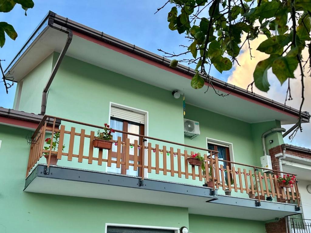 a balcony of a house with potted plants on it at La casetta verde in Villa Verde