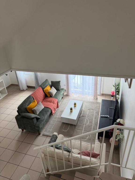 a living room with a couch and a table at Maison familiale in Gonesse