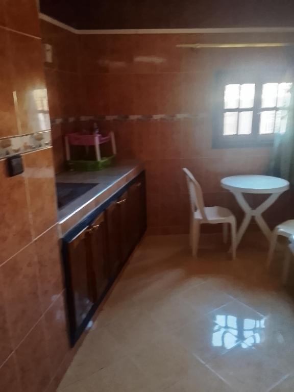 a small kitchen with a sink and a table at Premium Services in Tatta