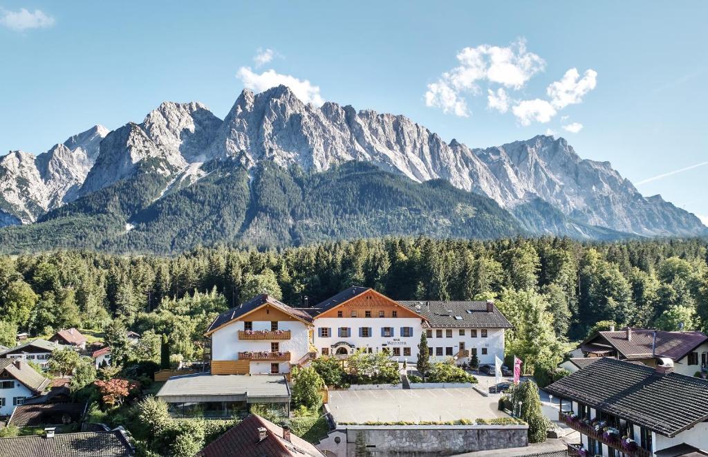 a village with a mountain in the background at Romantik Alpenhotel Waxenstein in Grainau