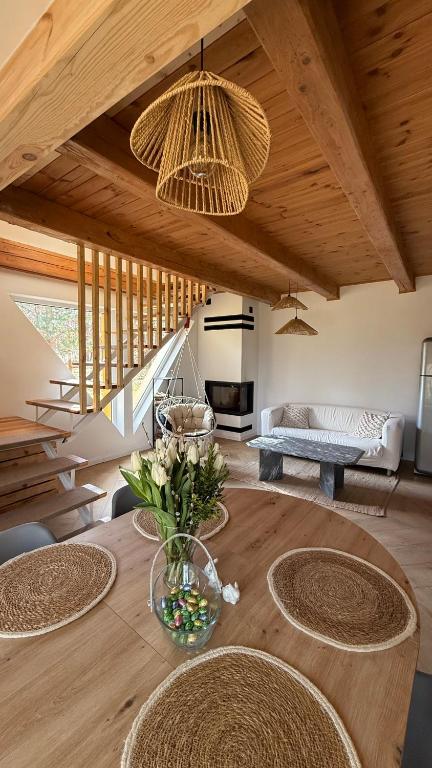a living room with a wooden table with chairs at Szałas na Hałas in Lubiana