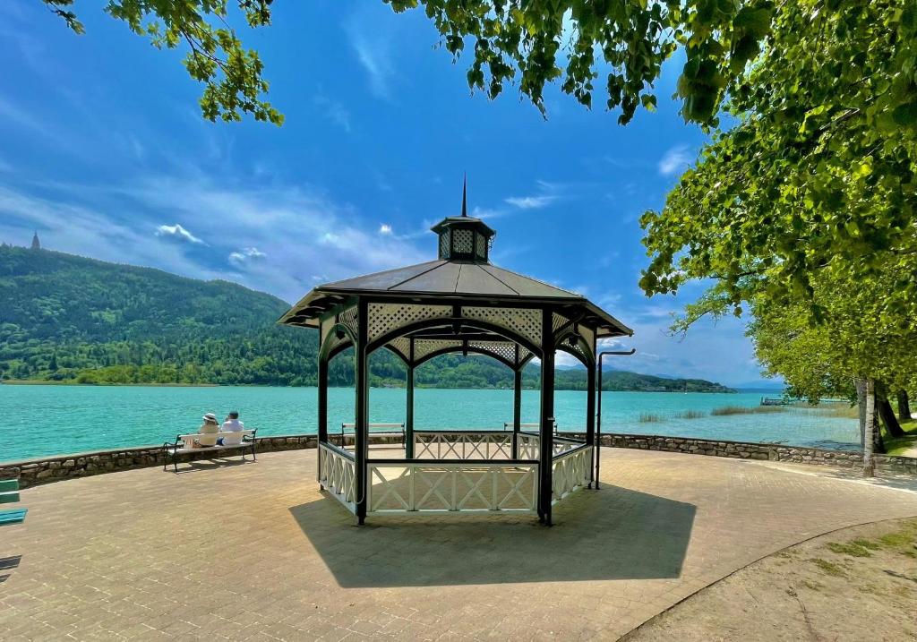 a gazebo next to a body of water at Appartement Eveline Pörtschach in Pörtschach am Wörthersee