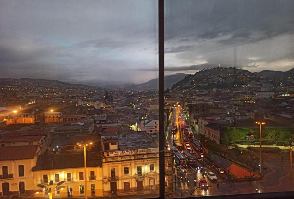 a view of a city at night with traffic at Vive el esplendor del Centro Histórico in Quito