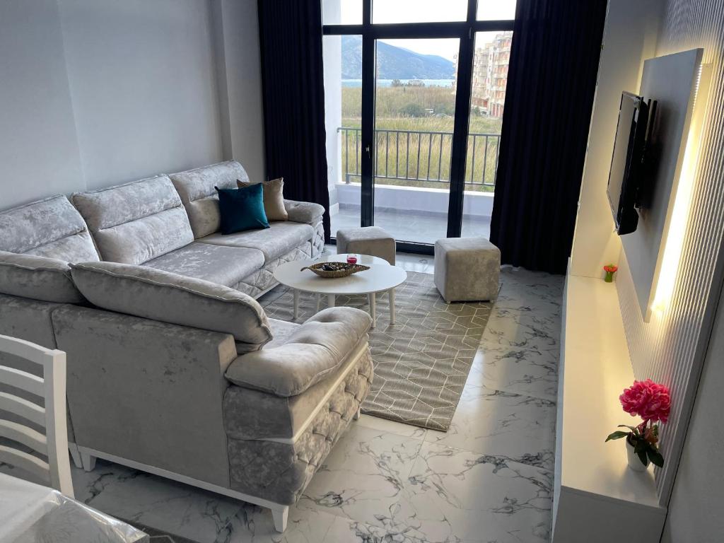a living room with a couch and a table at Sunset Apartment in Orikum
