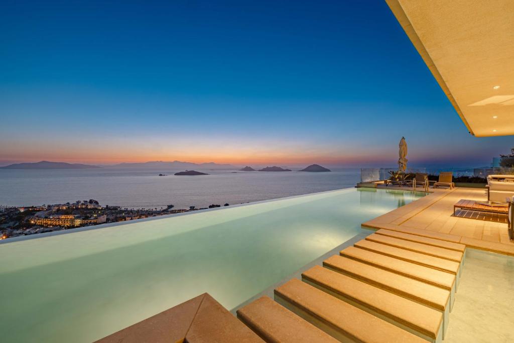 a infinity pool with a view of the ocean at Villa View Bodrum Infinity Pool Sunset over Greek Islands Private Concierge Breakfast Up to 10 Guests in Bodrum City
