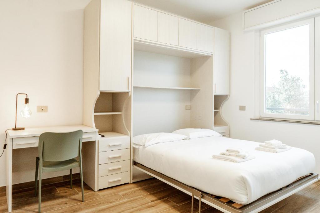 a bedroom with a bed and a desk at Silvia's Luxury Suites by RentMax in Canegrate
