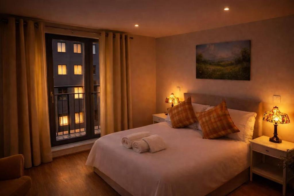a bedroom with a large white bed with a window at New,London Hideaway Studio in Woking