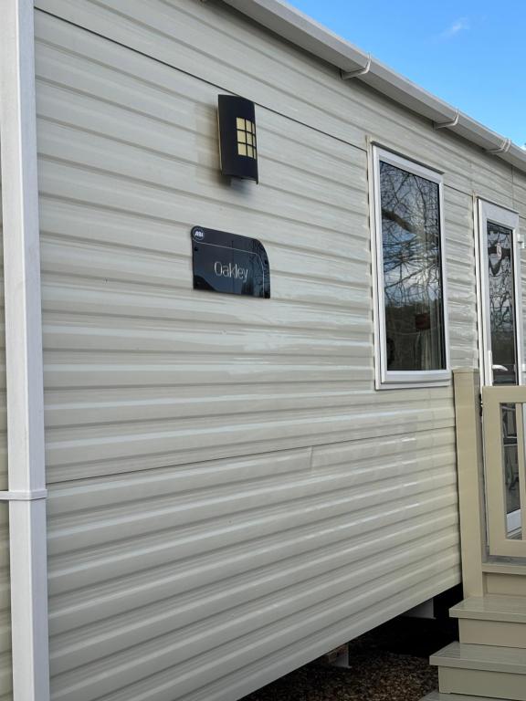 a building with a sign on the side of it at Oakley caravan rental in Skegness