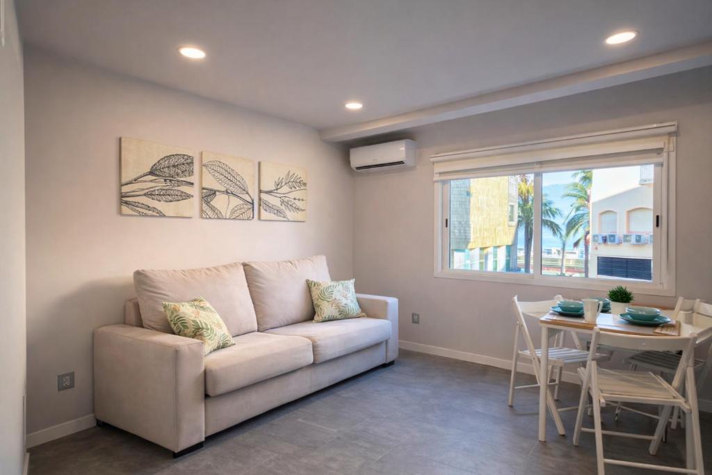 a living room with a couch and a table at Suites Prieto Fuengirola Centro in Fuengirola