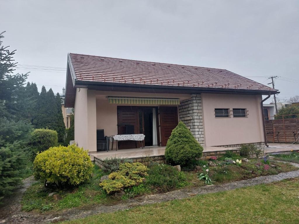 a small house with a bench in a yard at Balaton Breeze Retreat in Balatonfüred