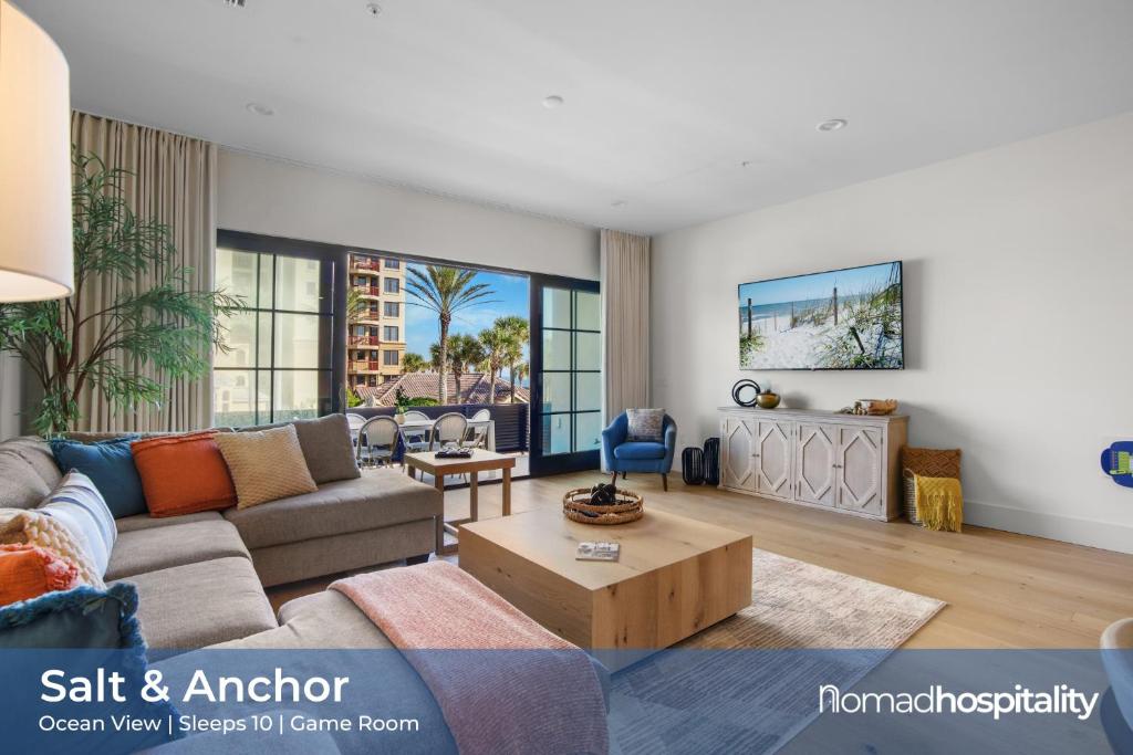 a living room with a couch and a table at Be A Nomad - Oceanview Luxe, 5BR Retreat in Jacksonville Beach