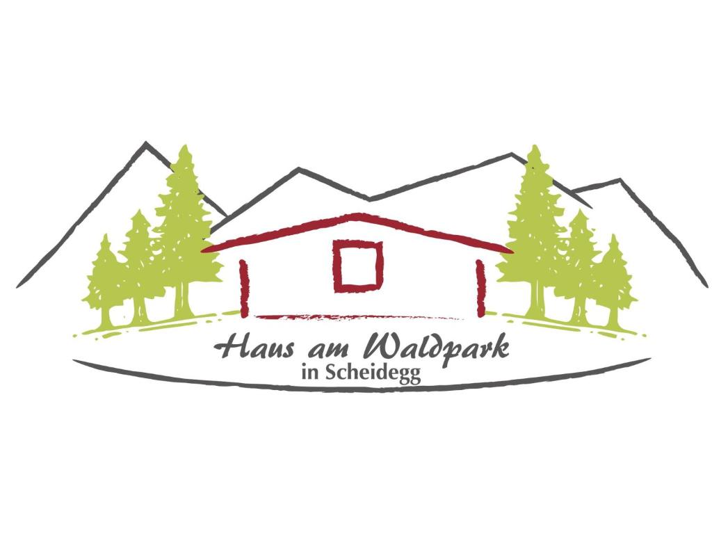 avere un meraviglioso cartello di vacanza di fronte a una casa con alberi di Haus am Waldpark a Scheidegg