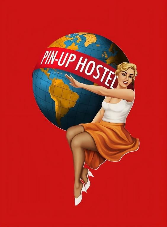 a woman is holding a sign that reads im up tosie at Pin-up hostel in Rosario