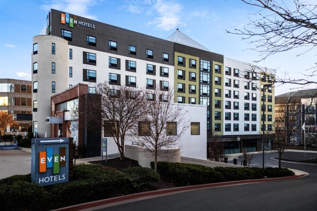 a hotel building with a sign in front of it at EVEN Hotel Rockville - Washington, DC Area by IHG in Rockville