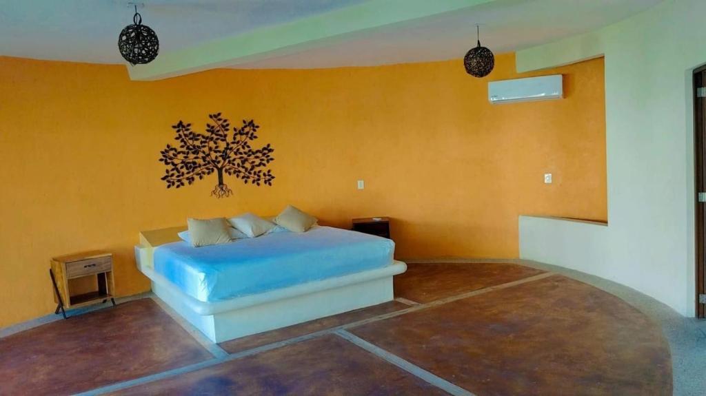 a bedroom with a blue bed in a room at Laguinn Hotel Acapulco in Acapulco