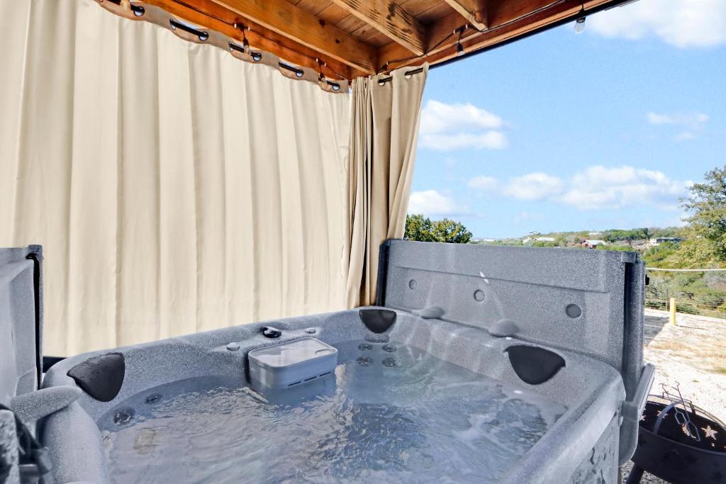 a hot tub in front of a window at The Container Retreat - 1A.. in Canyon Lake