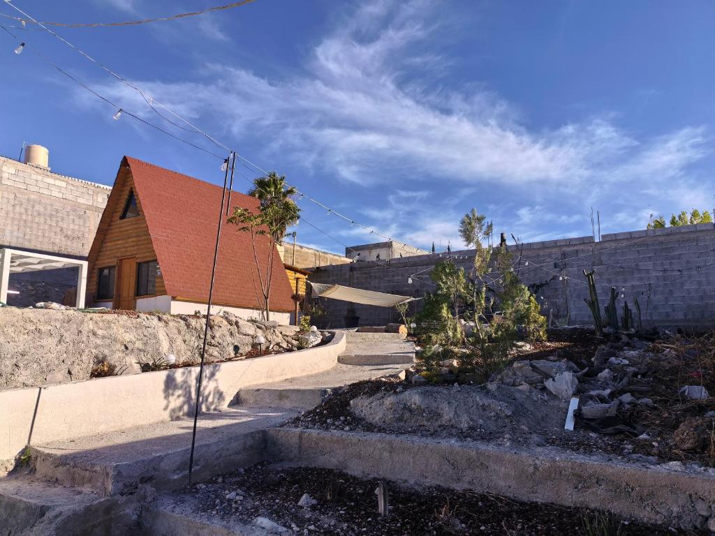 a house reconstruction with stairs leading to a building at Cabaña Alpina Saltillo in Saltillo