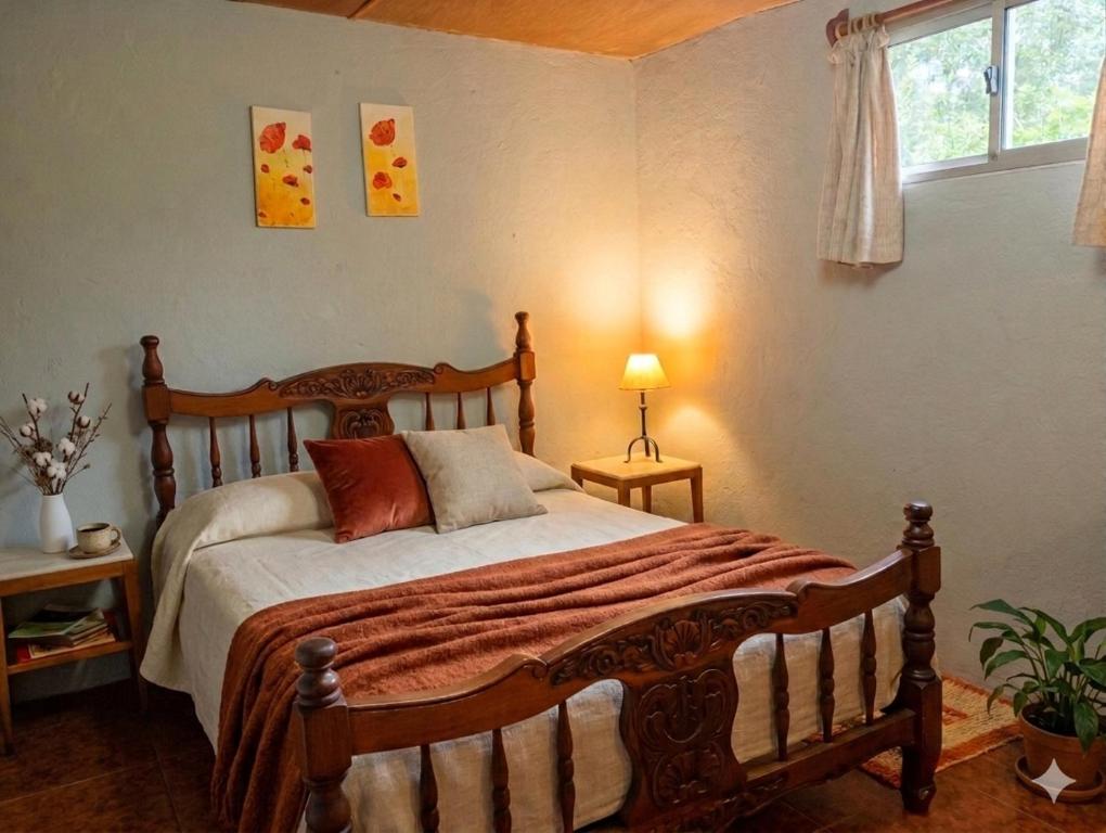 a bedroom with a wooden bed and a window at Refugio El Dormilón, Jardín cercado, Wifi, Playa 300 m, Pet friendly in La Pedrera