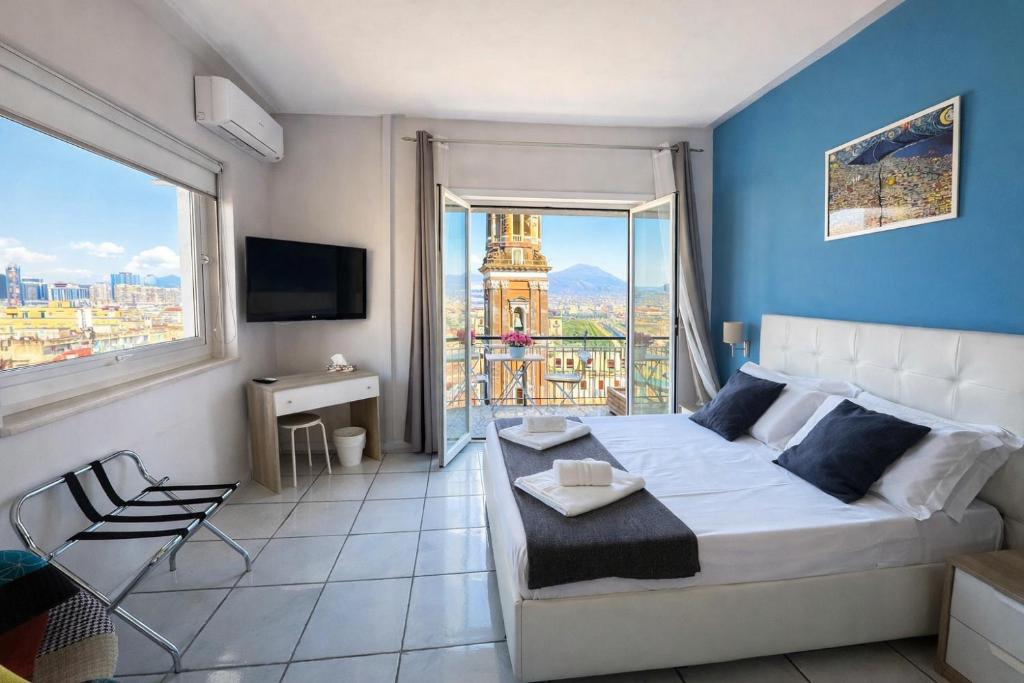 a bedroom with a large bed and a large window at La Casa di Giorgio Panoramic Rooms in Naples