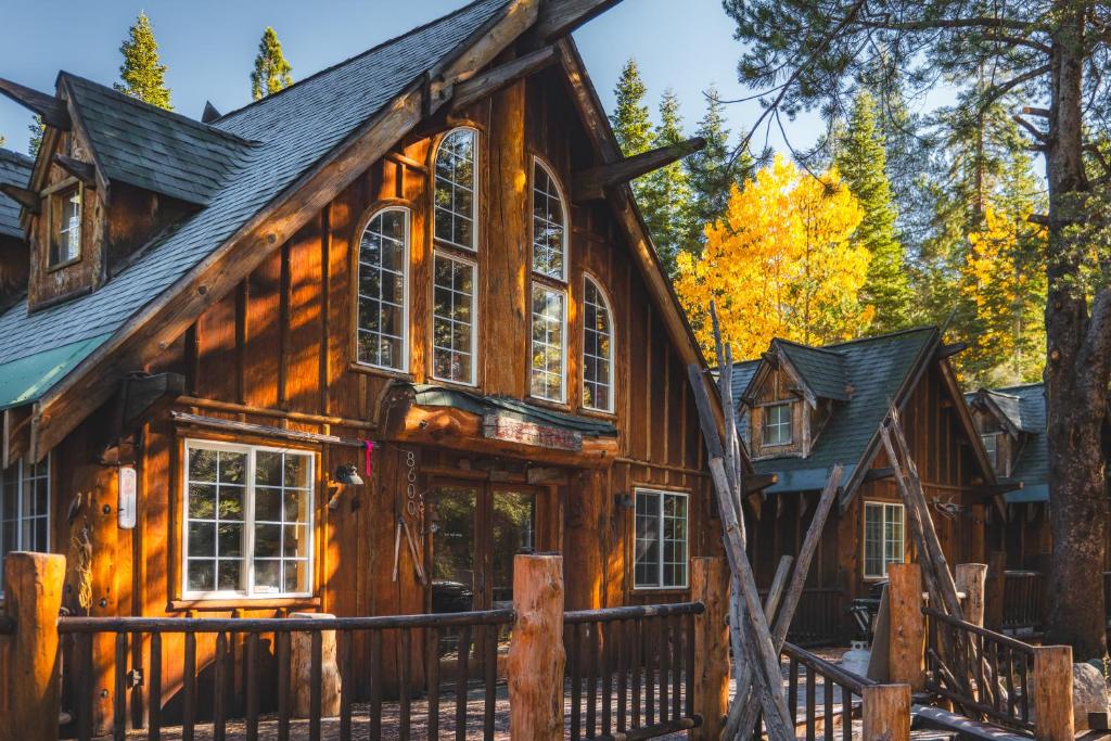 a log cabin in the woods with trees at Campfire Ranch All-Inclusive Lodge in Truckee