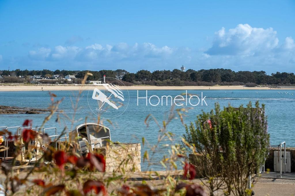 a view of a body of water with a honda sign at Sea-view garden-level flat in Ploemeur