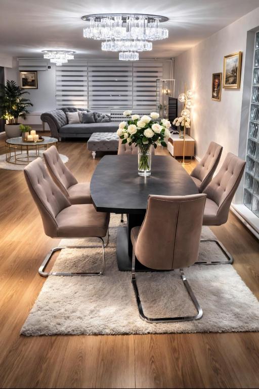 a living room with a table and chairs at AR Vila Kikinda in Kikinda