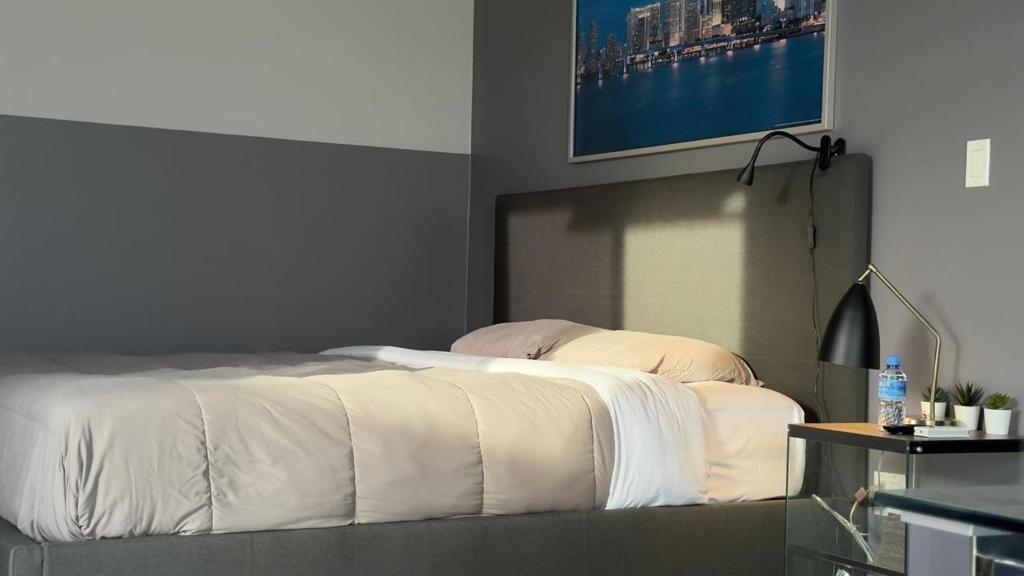 a bedroom with a bed with a tv on the wall at RC Apartments Suriname in Paramaribo
