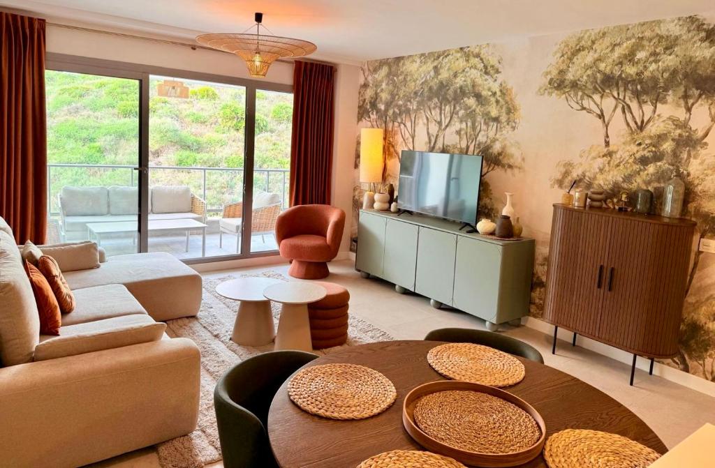 a living room with a couch and a table at Palm Forest Oasis in Mijas Costa