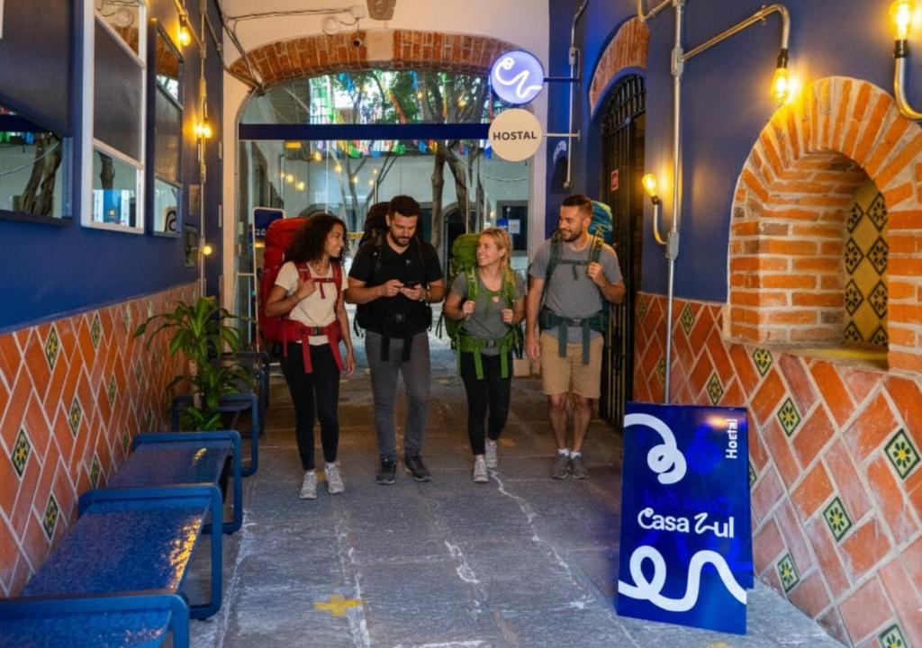 a group of people walking down a hallway at Hostalgia Casa Zul in Puebla