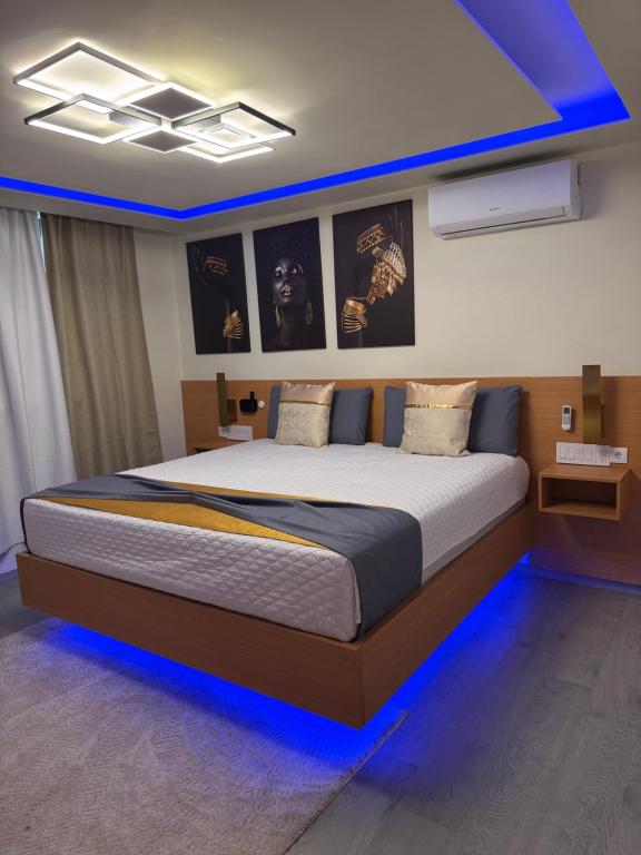 a bedroom with a large bed with blue lighting at N3XT LEVEL home in Praia