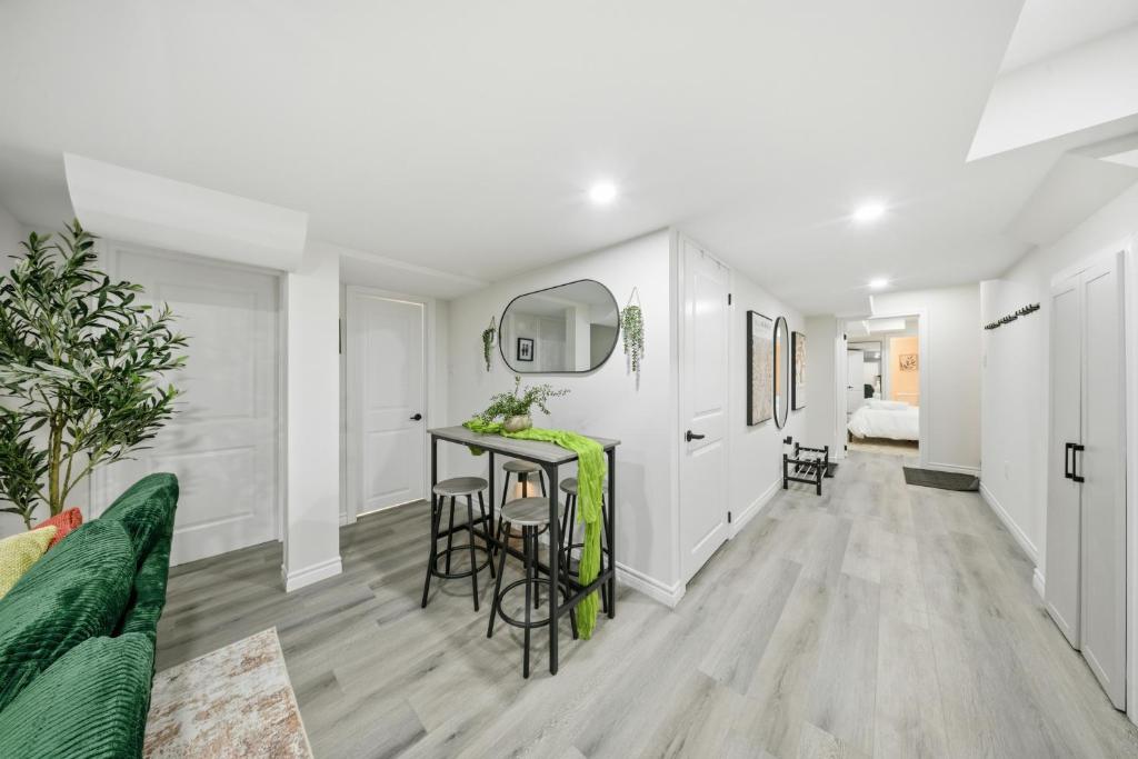 a living room with a green couch and a table at Caledon Quiet Luxury Escape 3BR Suite in Brampton