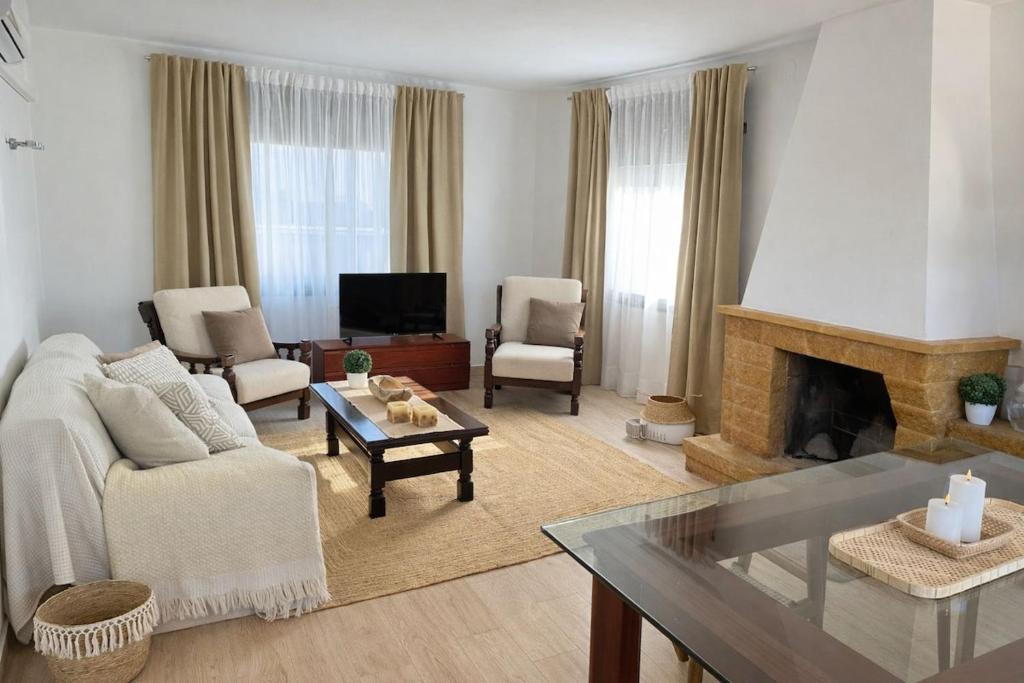 a living room with a couch and a fireplace at CASA DEL MAR-Costa Daurada in Cunit