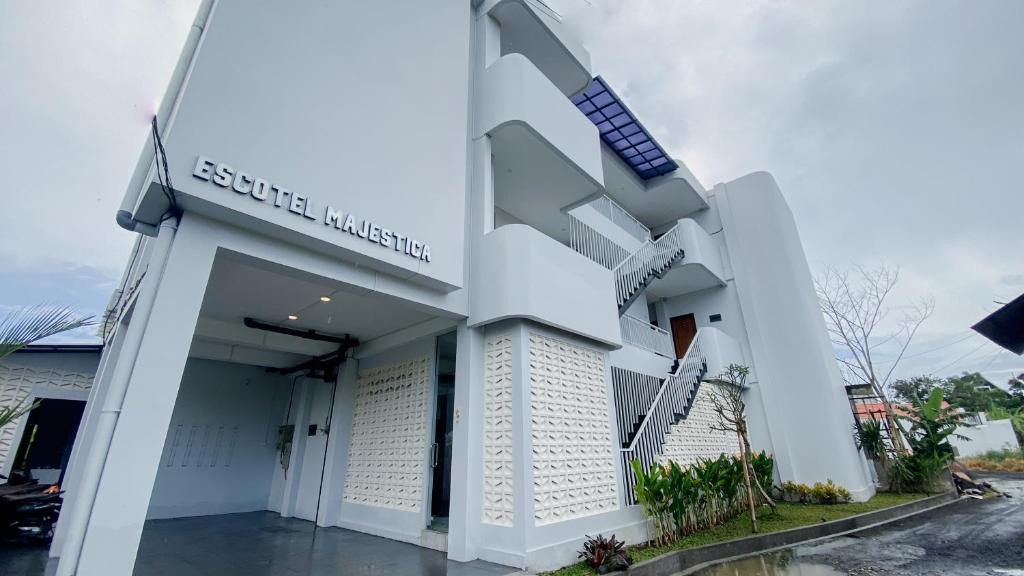 a white building with a scientology sign on it at Escotel Majestica in Dalung