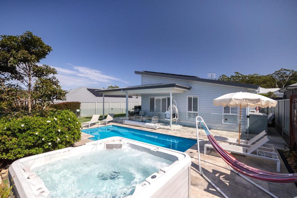 a swimming pool in front of a house at Casa Azul in Burrill Lake