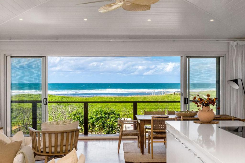 a living room with a view of the ocean at The Beach House in Lennox Head