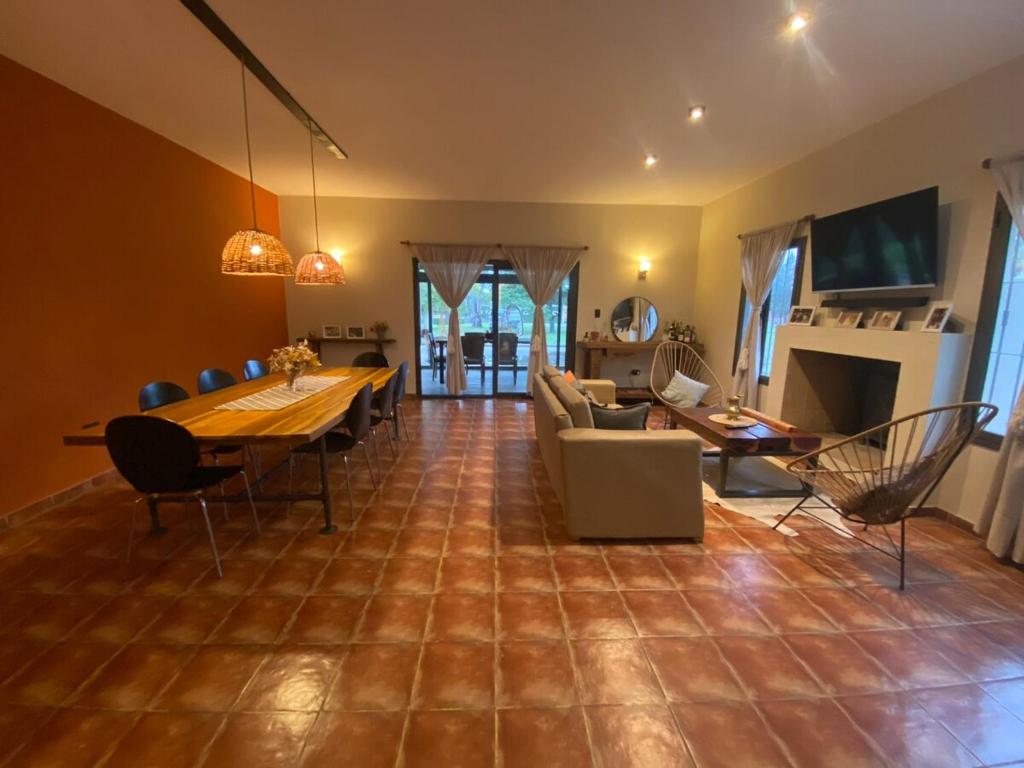 a living room with a table and a dining room at Casa Quinta in Córdoba