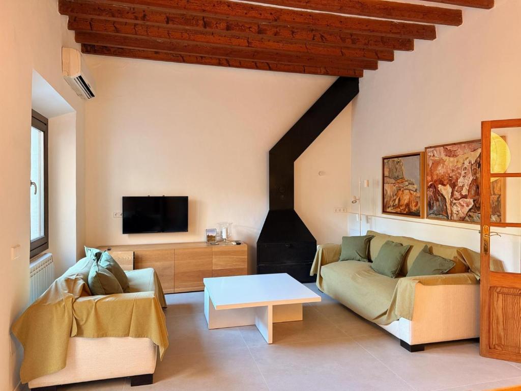 a living room with a couch and a table at Manyolas 93 in Alaró