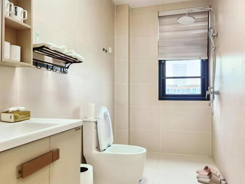 a white bathroom with a toilet and a window at Luke Cloud GSHT Store in Luoyang