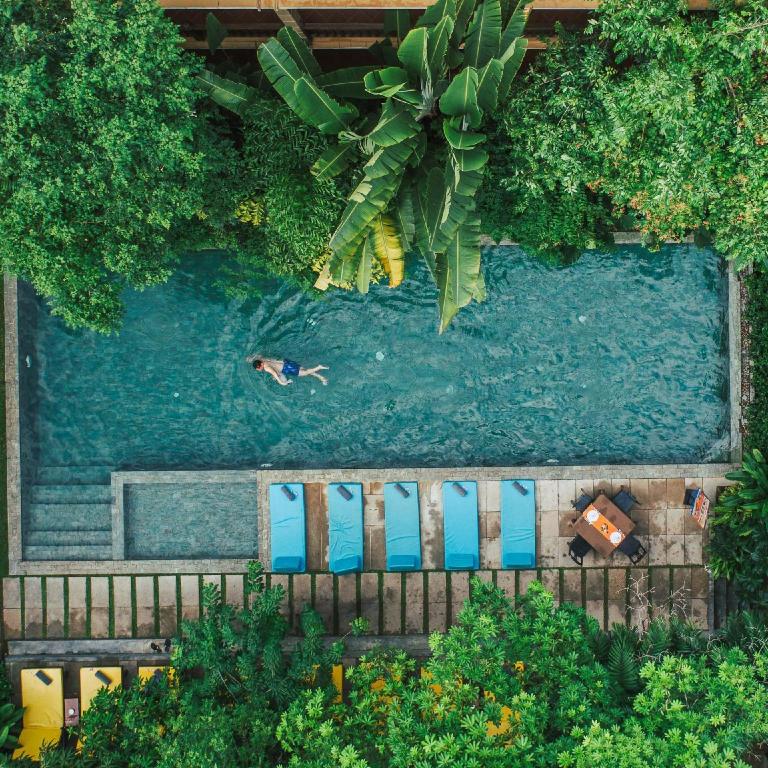 an overhead view of a pool with a person swimming in it at Indochine Serenity Boutique in Siem Reap