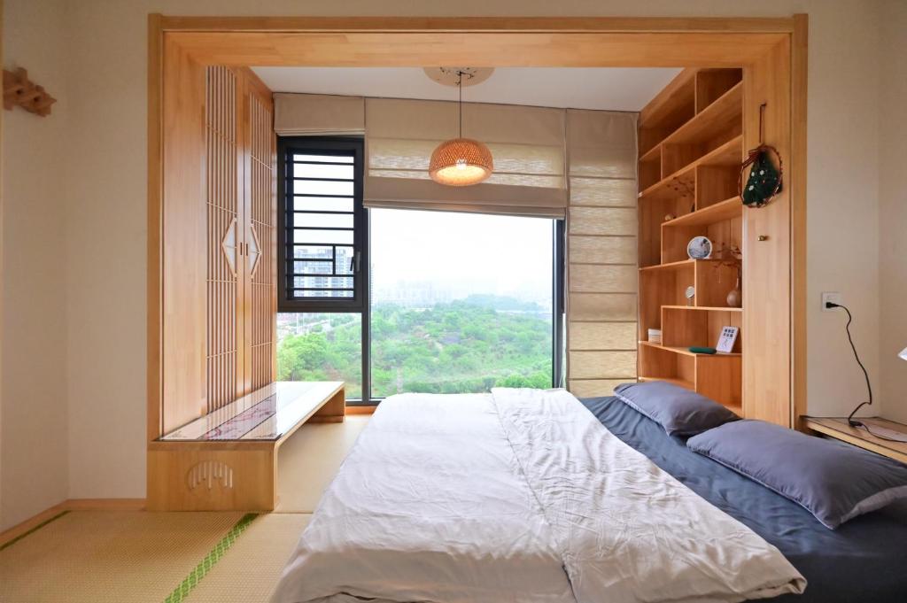 a bedroom with a bed and a large window at Xia Jiming-s store in Ganzhou