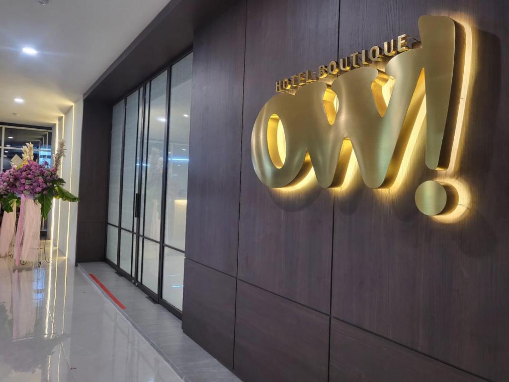 a sign on the side of a building with the word ay at Ow! Hotel Boutique Kemayoran in Jakarta