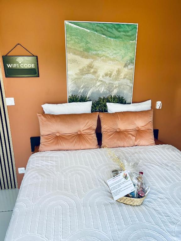 a bedroom with a bed with a basket on it at Domaine Maud-Jardin de Maud ! 100m plage in Saint-Pierre