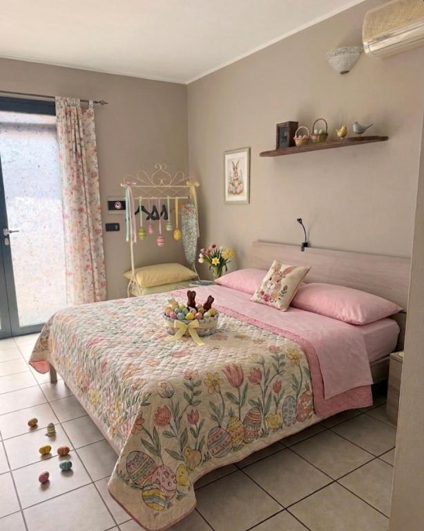 a bedroom with a bed with a tray of fruit on it at Il Cortiletto in Assemini