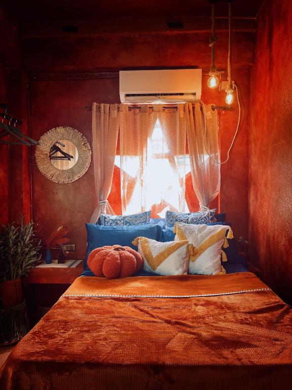 a bedroom with a bed with a window at Alter Space Workspace and CoLiving in General Luna