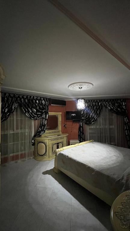 a bedroom with a large bed and a fireplace at Nador in Nador