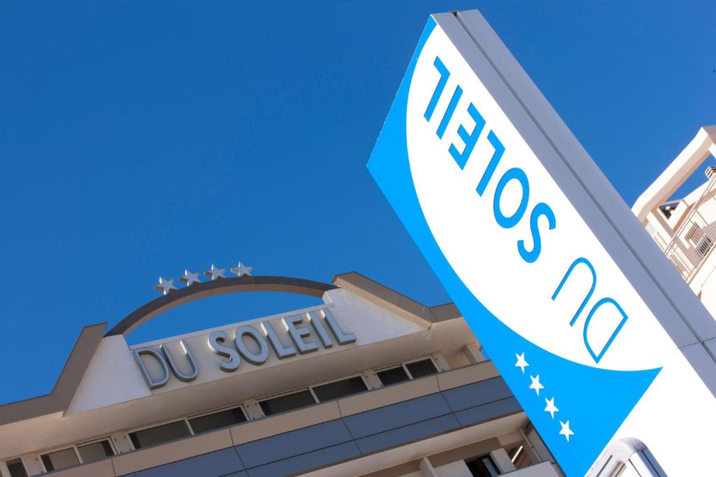 a building with a uvu sign in front of it at Hotel Du Soleil in Rimini