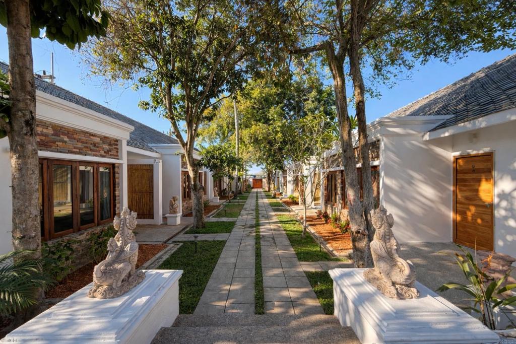 a street in front of a house with trees at Glory Moon Resort in Bophut