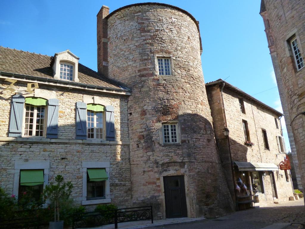 un antiguo edificio de ladrillo con una torre alta en Camping de Tournus - Drole de cabane en Tournus